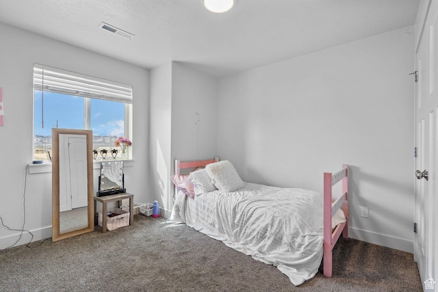 bedroom with visible vents, baseboards, and carpet