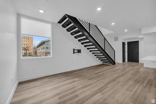 933 S Washington St Unit 107, Salt Lake City, UT 84101 - unfurnished living room featuring light wood-style floors, stairs, visible vents, and recessed lighting