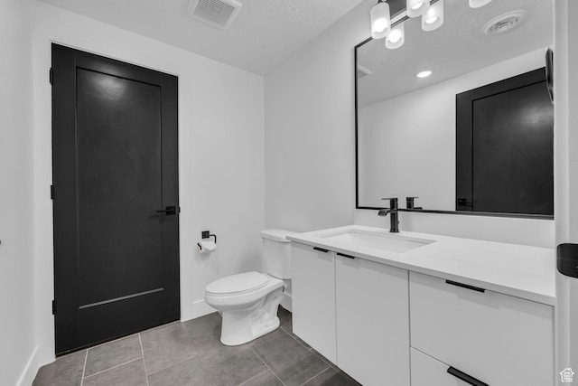 933 S Washington St Unit 107, Salt Lake City, UT 84101 - bathroom featuring tile patterned floors, vanity, visible vents, and toilet