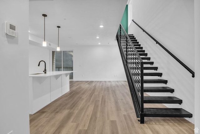 933 S Washington St Unit 107, Salt Lake City, UT 84101 - stairway with baseboards, recessed lighting, and wood finished floors