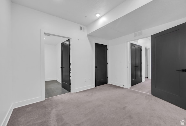 933 S Washington St Unit 107, Salt Lake City, UT 84101 - unfurnished bedroom featuring visible vents, baseboards, and carpet flooring