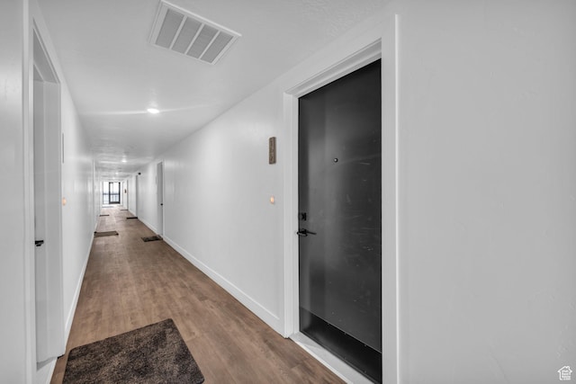 933 S Washington St Unit 107, Salt Lake City, UT 84101 - hallway with wood finished floors, baseboards, and visible vents