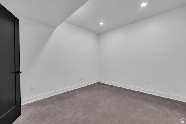 933 S Washington St Unit 107, Salt Lake City, UT 84101 - spare room with recessed lighting, baseboards, dark carpet, and lofted ceiling