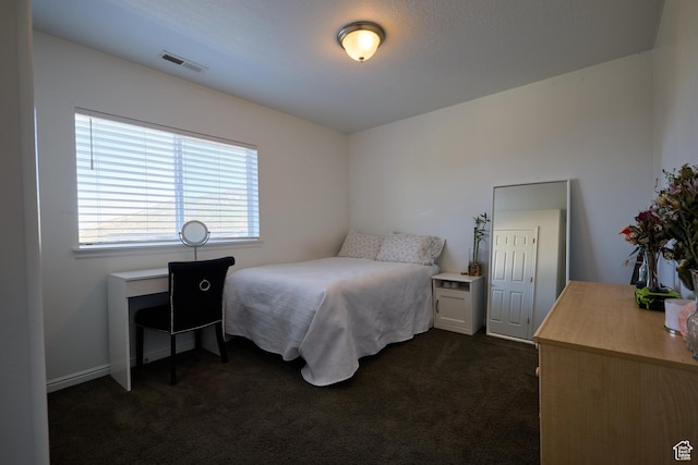 bedroom with visible vents and dark colored carpet