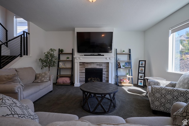 living area featuring a fireplace and dark carpet
