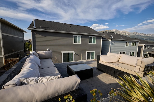 back of property featuring a patio area, outdoor lounge area, and a mountain view