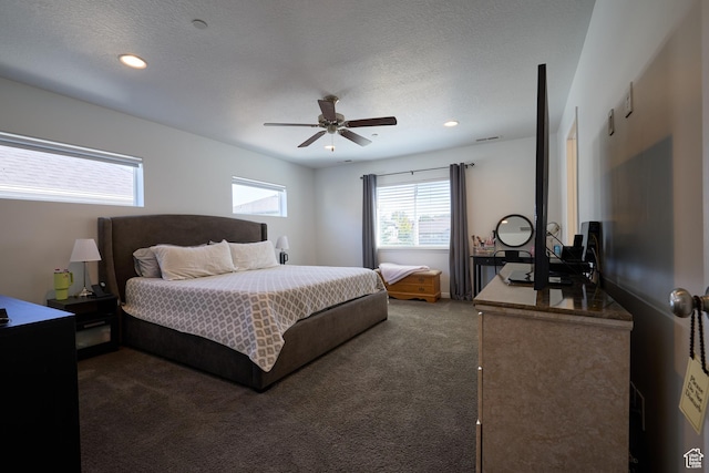 bedroom featuring ceiling fan, recessed lighting, dark colored carpet, and a textured ceiling