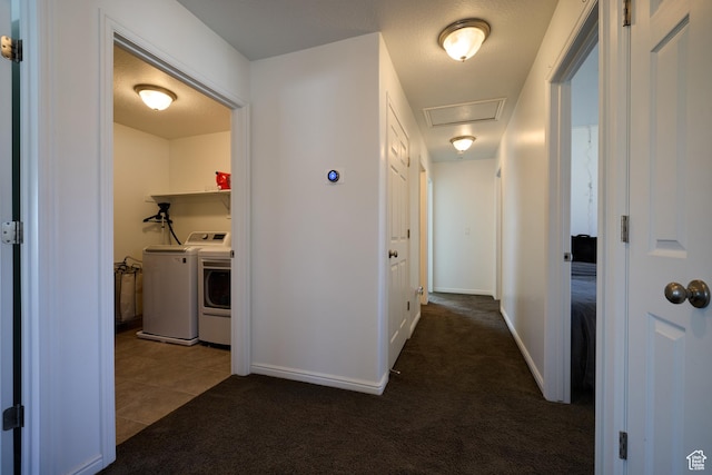 corridor with carpet floors, washer and clothes dryer, baseboards, and tile patterned floors