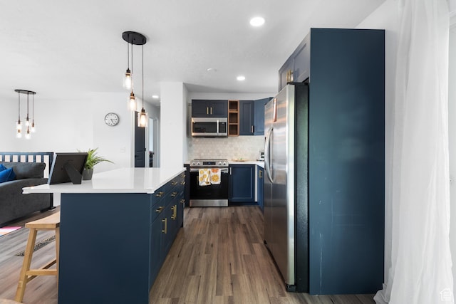 8235 S 1640 W, West Jordan, UT 84088 - kitchen featuring light countertops, dark wood finished floors, stainless steel appliances, decorative backsplash, and blue cabinetry