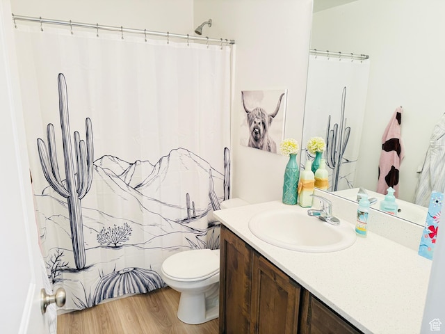 full bath with toilet, curtained shower, wood finished floors, and vanity