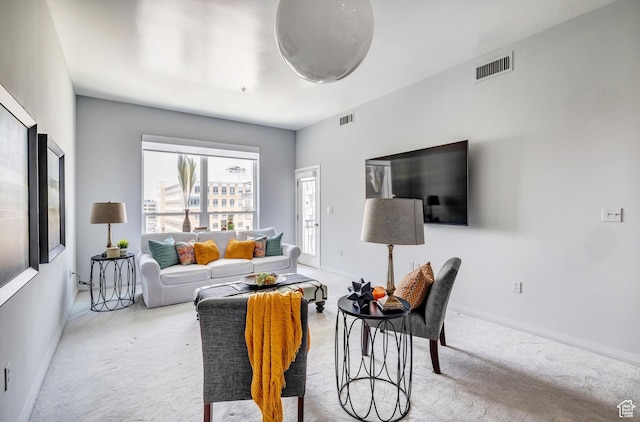 living room with carpet flooring, baseboards, and visible vents