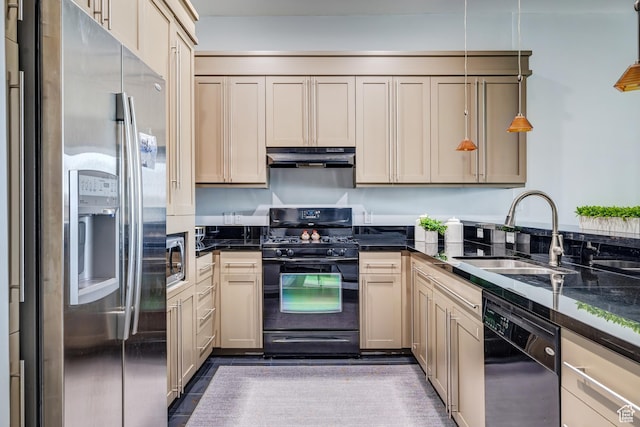 kitchen with dark stone countertops, decorative light fixtures, a sink, under cabinet range hood, and black appliances