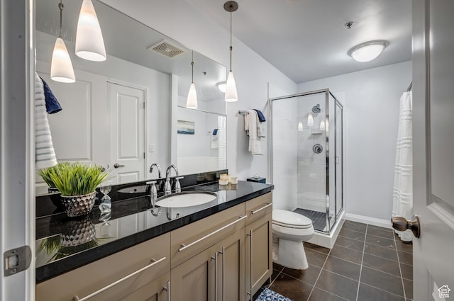 full bathroom featuring visible vents, toilet, a shower stall, vanity, and tile patterned flooring