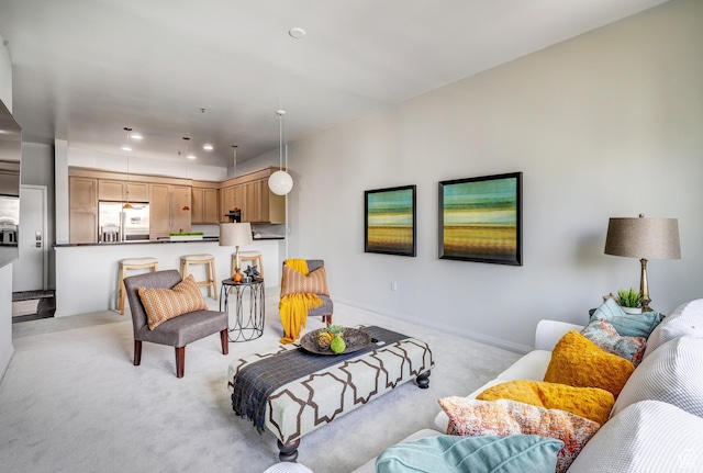 living room featuring light carpet, recessed lighting, and baseboards