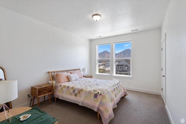 carpeted bedroom featuring visible vents and baseboards
