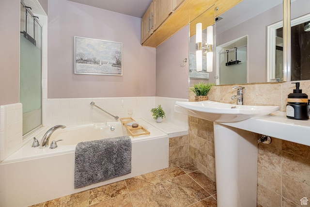 2356 E 3900 S, Millcreek, UT 84124 - bathroom with a bath, decorative backsplash, and stone finish flooring