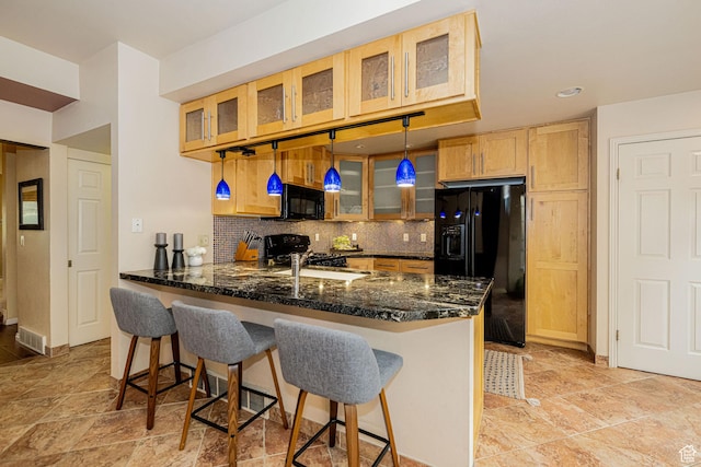 2356 E 3900 S, Millcreek, UT 84124 - kitchen featuring black appliances, a peninsula, backsplash, glass insert cabinets, and dark stone countertops