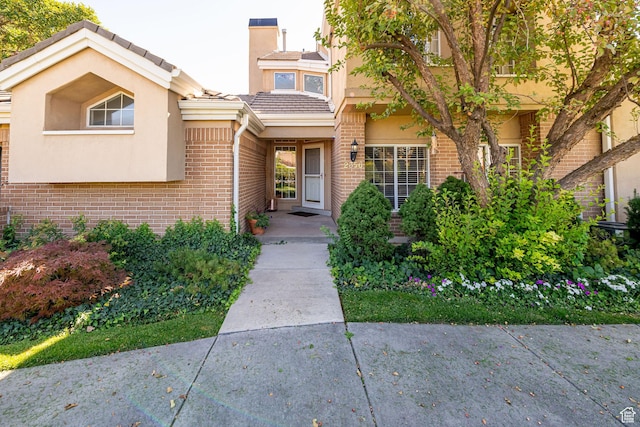 2356 E 3900 S, Millcreek, UT 84124 - property entrance featuring brick siding, stucco siding, and a tile roof