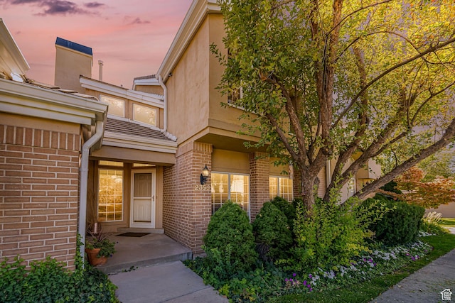 2356 E 3900 S, Millcreek, UT 84124 - doorway to property featuring brick siding and stucco siding
