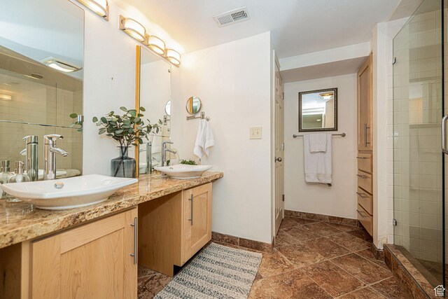 2356 E 3900 S, Millcreek, UT 84124 - bathroom with double vanity, a tile shower, and stone tile floors