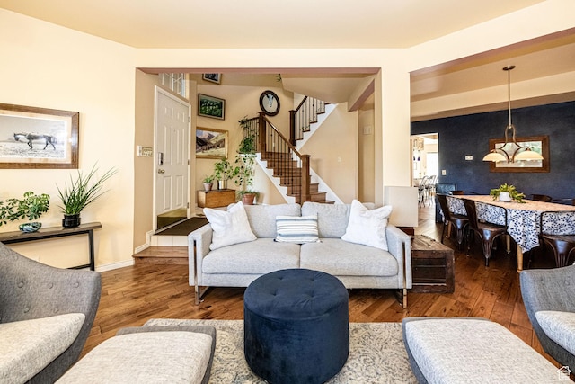 living room with baseboards, stairway, and wood finished floors