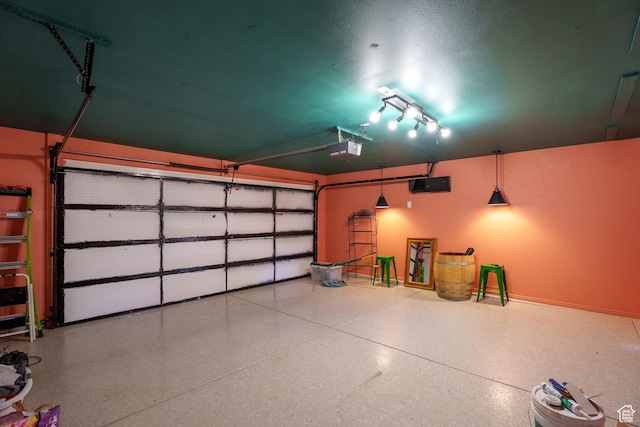 garage featuring a garage door opener and baseboards