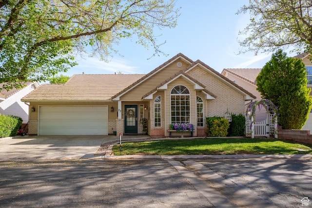 single story home with a garage, brick siding, driveway, and a tiled roof