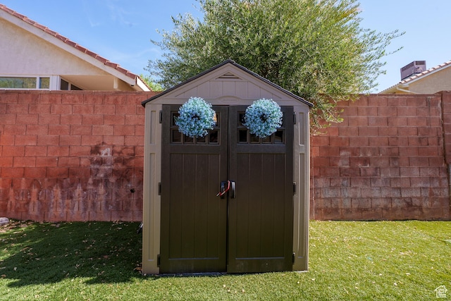 view of shed featuring fence
