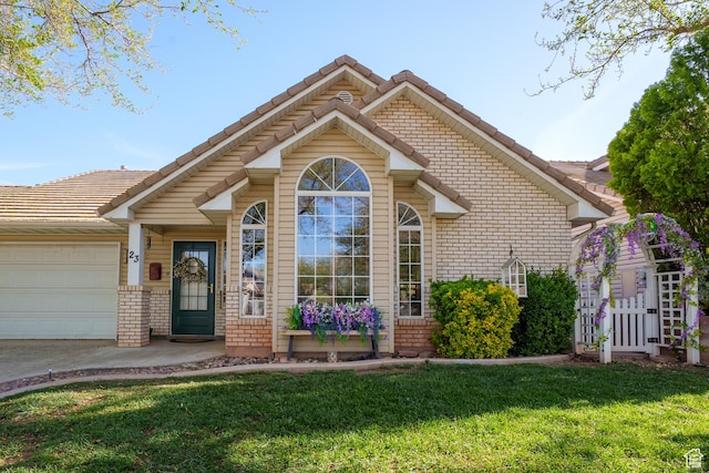 ranch-style house featuring brick siding, a front yard, an attached garage, and a tiled roof