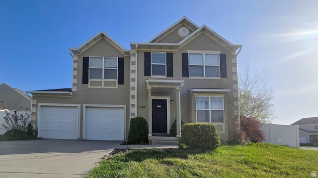 1397 W Archmore Dr, Springville, UT 84663 - view of front of home featuring concrete driveway, stucco siding, a front lawn, and a garage