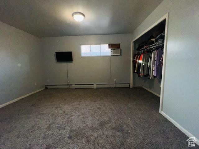 unfurnished bedroom with a baseboard radiator, a closet, baseboards, and carpet floors