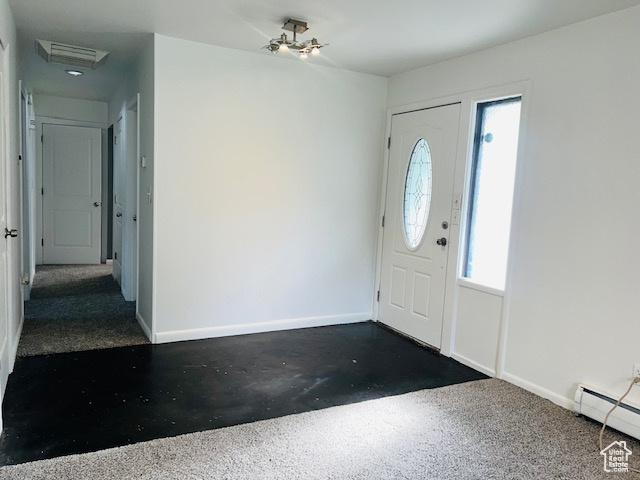 entryway with concrete floors, baseboards, and baseboard heating
