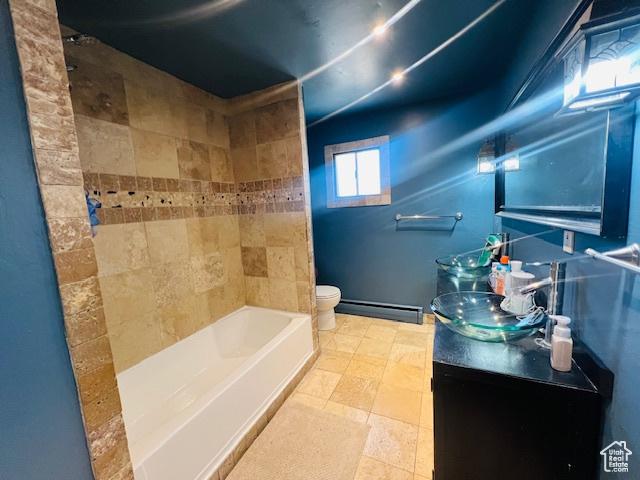 bathroom featuring baseboard heating, vanity, and toilet