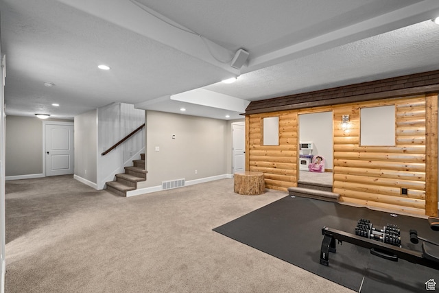 exercise area featuring recessed lighting, baseboards, a textured ceiling, and carpet floors