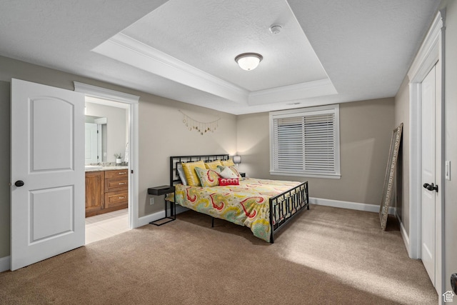 bedroom with baseboards, a raised ceiling, a textured ceiling, crown molding, and light carpet