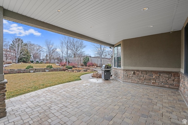 view of patio featuring grilling area and fence