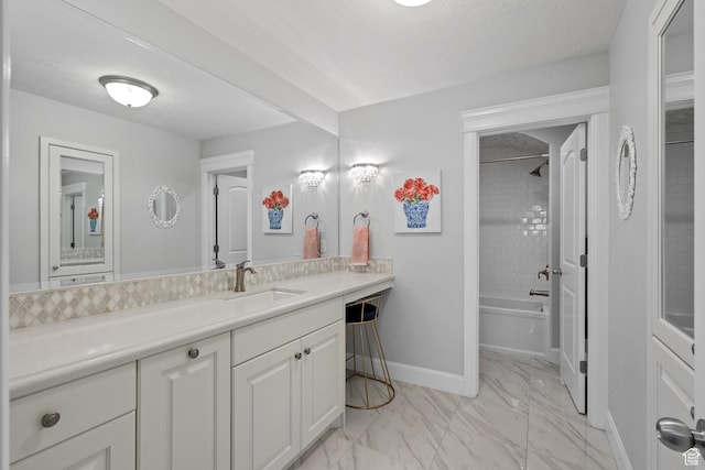 bathroom with shower / tub combination, marble finish floor, baseboards, and vanity
