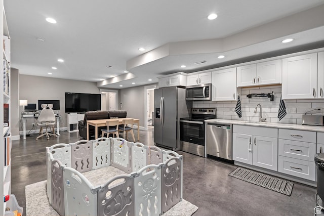 living room with concrete floors, visible vents, baseboards, and recessed lighting