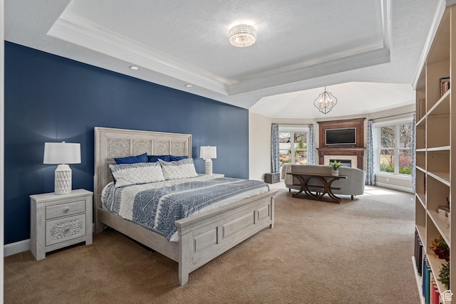 carpeted bedroom with crown molding, a tray ceiling, a notable chandelier, and a textured ceiling