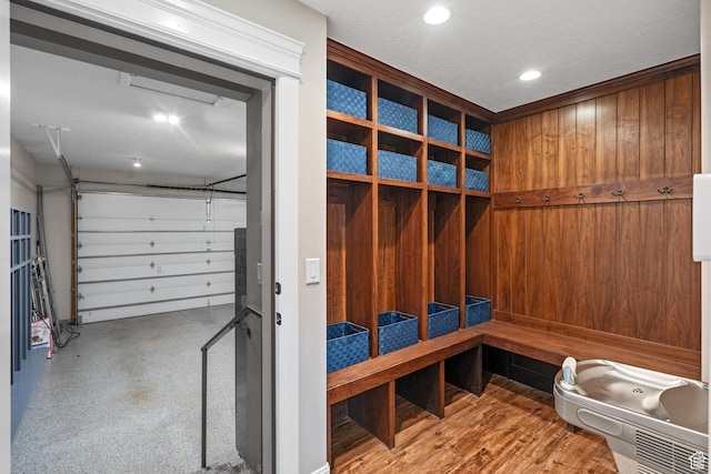 mudroom with a sauna, recessed lighting, and wooden walls