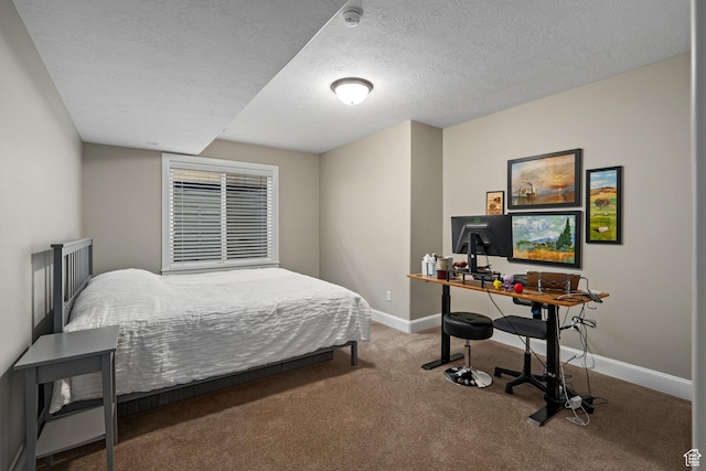 bedroom with baseboards, carpet, and a textured ceiling