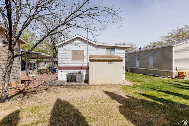 1160 E Telegraph St S Unit 32, Washington, UT 84780 - back of house with an outbuilding, central AC unit, and a lawn