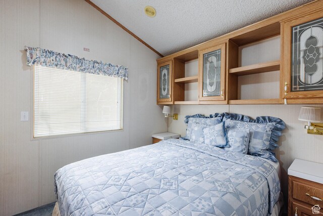 1160 E Telegraph St S Unit 32, Washington, UT 84780 - bedroom featuring a textured ceiling, vaulted ceiling, and ornamental molding