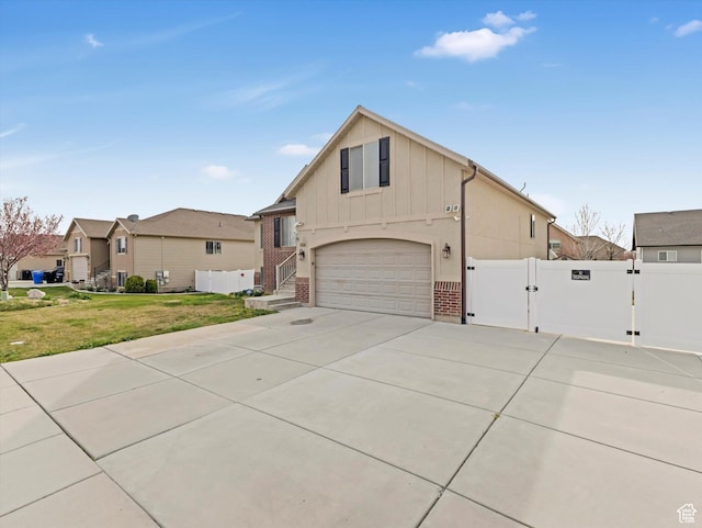 3057 N 3325 W, Plain City, UT 84404 - view of front of house with a garage, board and batten siding, a front lawn, a gate, and driveway