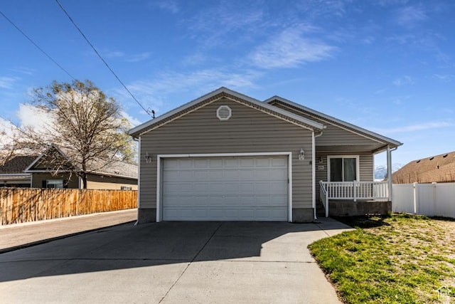 ranch-style home featuring fence, an attached garage, a porch, and concrete driveway