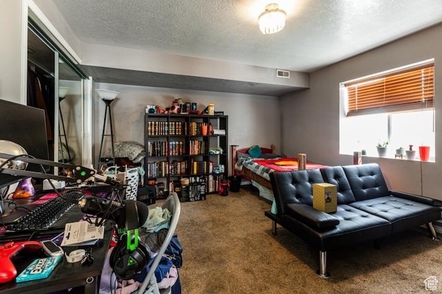 carpeted bedroom with a textured ceiling and visible vents