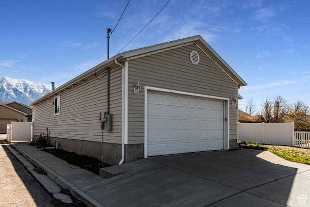 garage with fence and a mountain view
