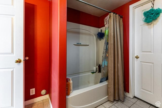 bathroom with shower / bath combo, baseboards, and tile patterned flooring