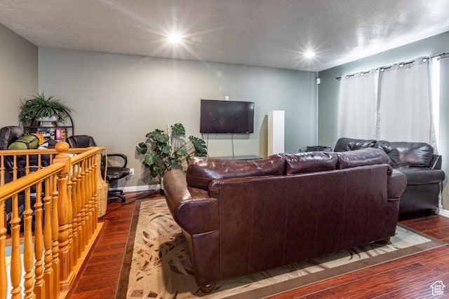 living room with baseboards, wood finished floors, and recessed lighting