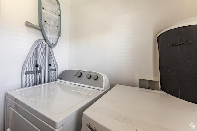 laundry area with washing machine and clothes dryer and laundry area